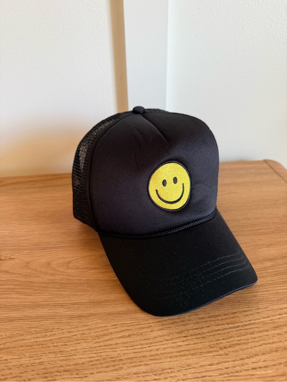 Black Trucker Hat with Yellow Smiley Patch